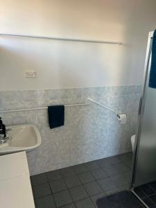a bathroom with a sink and a toilet at Beach House Studio in Busselton +7 photos