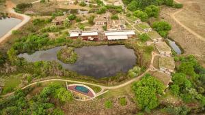 an aerial view of a house with a pond at Forum Homini Boutique Hotel in Krugersdorp