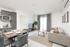 a kitchen and living room with a table and a couch at The Bantree by Clifton Homes in Accra