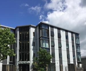 an office building with black and white windows at DatePalm CBD & Central Akl in Auckland