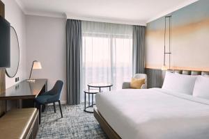 a hotel room with a bed and a desk at London Marriott Hotel Marble Arch in London