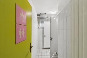 a bathroom with green and white walls and a green wall at Sigma Self Check-in Hostel in Zurich +26 photos