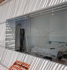 a room with a window with a bed in it at 3B MAISON Homestay & Villa in Mui Ne +38 photos