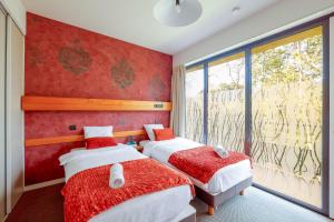 a bedroom with two beds and a window at Logis Hôtel Le Keréden in Locarn