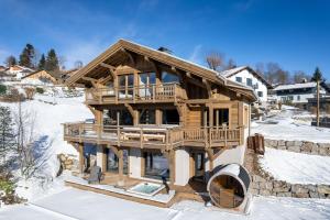 a log home being built in the snow at Sorelle Chalet, spa, indoor pool, lake view in Gérardmer