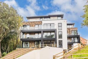 an image of a white building with stairs at Aurora South - Short Walk to Ashley Cross in Poole