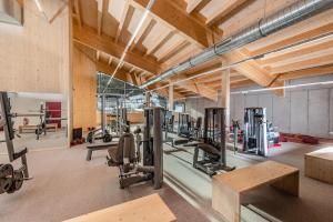 a gym with several treadmills and exercise equipment at Ramsaublick in Ramsau am Dachstein