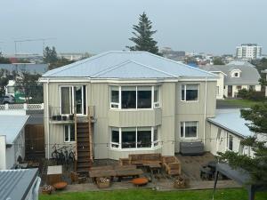 a large house with a deck and a patio at Reynisstaðir in Keflavík