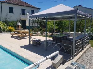 ein Pavillon neben einem Swimmingpool in der Unterkunft Luxury Private apartment FREE Play Park inc QUID BIKES PRIVATE Heated swimming pool in Sinde
