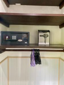 a microwave and a box on a shelf in a kitchen at Ubud jungle House behind bintang supermarket ubud in Ubud