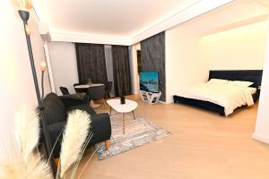 a living room with a bed and a couch at Cortina Nord Panoramic Studio in Voluntari