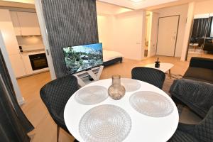 a living room with a white table and chairs at Cortina Nord Panoramic Studio in Voluntari