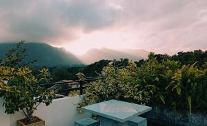 a table on a balcony with a view of a mountain at Aybo Soulscape Villa Dambulla in Dambulla