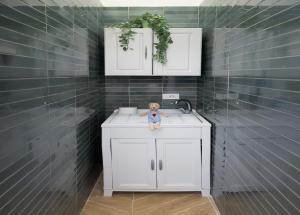 a teddy bear sitting on top of a bathroom sink at la dimora del Duca in Salerno +31 photos