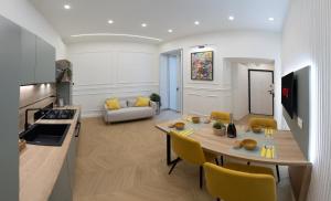 a kitchen and living room with a table and chairs at la dimora del Duca in Salerno