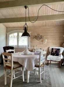 a dining room with a white table and chairs at Chalet de Charme in Aniane