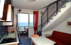 a kitchen with a staircase with a view of the ocean at Etruriamare in San Vincenzo