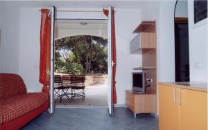 a living room with a door open to a patio at Etruriamare in San Vincenzo +30 photos