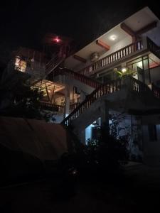 a building with a staircase in the night at Dreamcatcher House & Hostel at Arambol Beach in Arambol +63 photos
