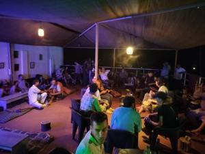 a group of people sitting in a tent at Dreamcatcher House & Hostel at Arambol Beach in Arambol