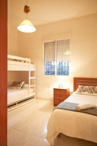 a bedroom with two bunk beds and a window at Espectacular chalet para descansar in Torrent +19 photos