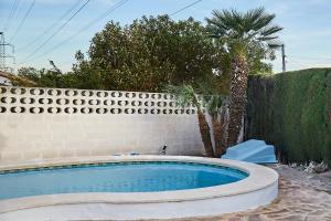 a swimming pool in a yard next to a fence at Espectacular chalet para descansar in Torrent