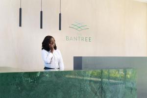 a woman talking on a cell phone in a lobby at The Bantree by Clifton Homes in Accra