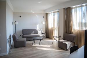 a living room with a couch and chairs and a table at Hotel Capannelle Roma in Rome