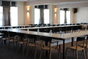 a large conference room with a large table and chairs at Hotel Porta 26 in Skopje