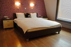 a bedroom with a large bed with two night stands at Hotel Porta 26 in Skopje