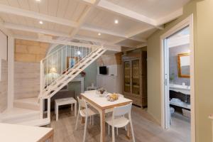 a kitchen and dining room with a staircase and a table at SASSO BIANCO in Matera