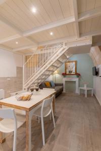 a living room with a table and a spiral staircase at SASSO BIANCO in Matera
