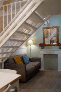 a living room with a couch and a staircase at SASSO BIANCO in Matera