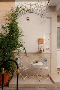 a patio with two chairs and a table at SASSO BIANCO in Matera