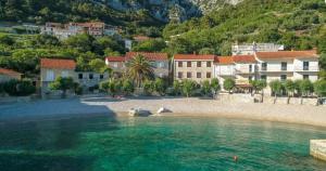 a beach with a group of buildings and a town at Apartment Feral in Orebić