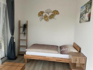 a bedroom with a bed and a shelf in a room at Sorinas Home - Comfortable Apartment near Graz - Free Parking in Wagersbach