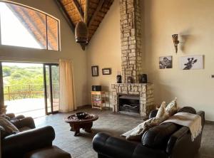 a living room with a couch and a fireplace at Rocky Valley Lakehouse in Pietermaritzburg