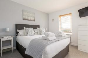 a bedroom with a bed with towels on it at Avalon - Walking Distance to Poole Quay and Town in Poole