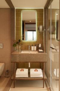 a bathroom with a sink and a mirror at Ruins Luxury Resort - Adults Only in Yalıkavak