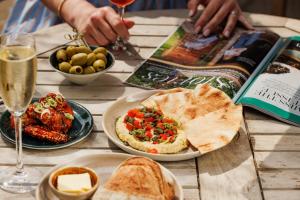 a table topped with plates of food and a book at Bear and Ragged Staff in Oxford +83 photos