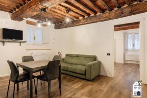 a living room with a couch and a table and chairs at I due Ciueli in Pescia