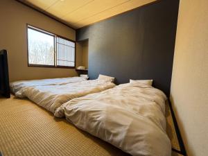 two large beds in a room with a window at Fuji-Kurohime- in Shinano
