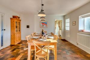 a dining room with a wooden table and chairs at Finest Retreats - The Old Windmill in Hindolveston
