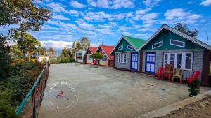 a row of colorful houses on a street at Kalden Homestay Sinji in Kalimpong