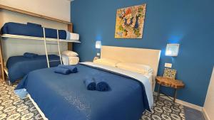 a blue bedroom with a bed with blue sheets at Torre Letus in Montallegro