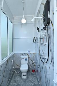 a bathroom with a toilet and a shower at Hureshan Villa in Negombo