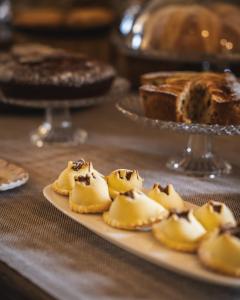 a plate of desserts on a table with cake at Antico Convento Dei Cappuccini in Ragusa