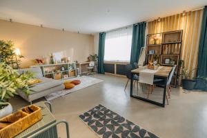 a living room with a couch and a table at Studio49apartments Quiet in Niš Free Private Parking Fast WiFi in Niš