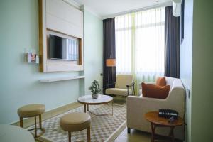 a living room with a couch and a tv at Best Western Dodoma City Hotel in Dodoma