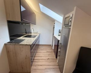 a kitchen with a sink and a counter top at Ferienwohnung Kramerblick Marienplatz in Garmisch-Partenkirchen +5 photos